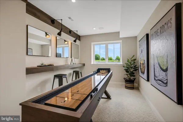 a living room with furniture and a view of kitchen