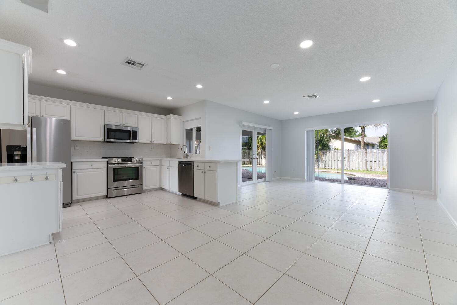 4695 Brandywine Drive Boca Raton, FL 33487 - Photo 6 of 28 a kitchen with stainless steel appliances a refrigerator and a stove top oven