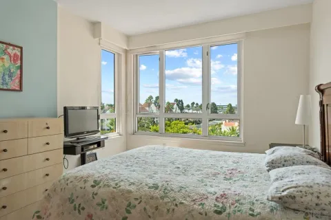 a bedroom with a bed and a large window