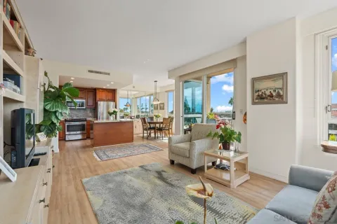 a living room with furniture and a view of kitchen