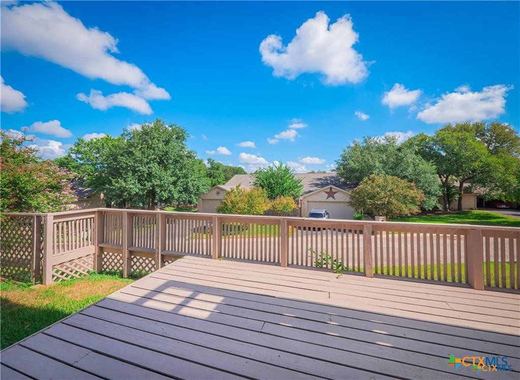 3901 Chisholm Trail, Unit 12 Salado, TX 76571 - Photo 3 of 9 a view of a deck with a chair and wooden floor
