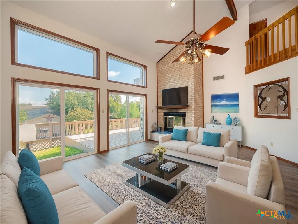 3901 Chisholm Trail, Unit 12 Salado, TX 76571 - Photo 4 of 9 a living room with furniture a fireplace and a large window