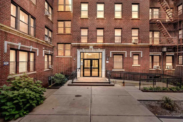 a front view of a brick building with many windows
