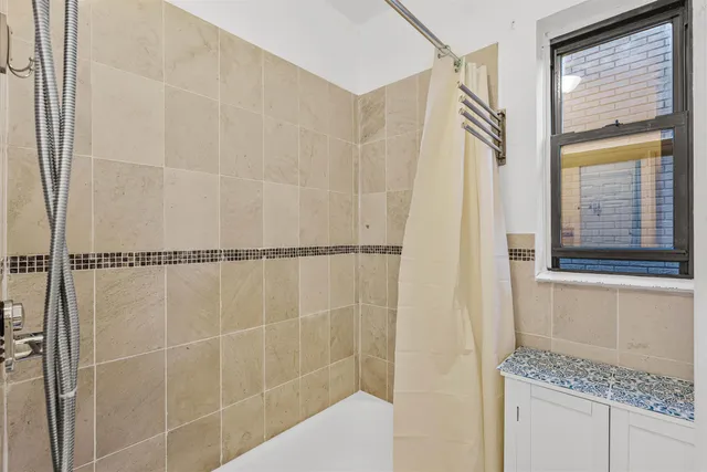 a bathroom with a granite countertop shower and a sink