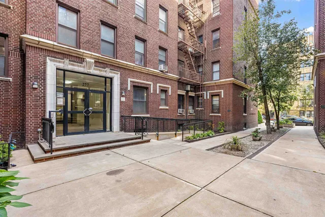 a street corner with a building in the background