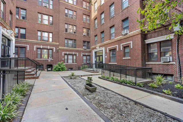 a view of a brick building next to a yard