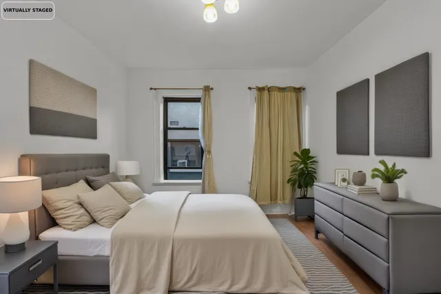 a spacious bedroom with a balcony a bed and a couch