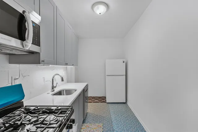 a kitchen with a sink and a stove top oven