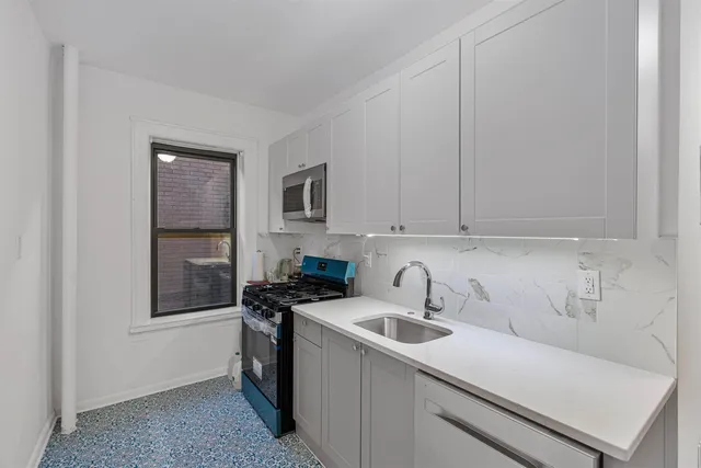 a utility room with sink dryer and washer