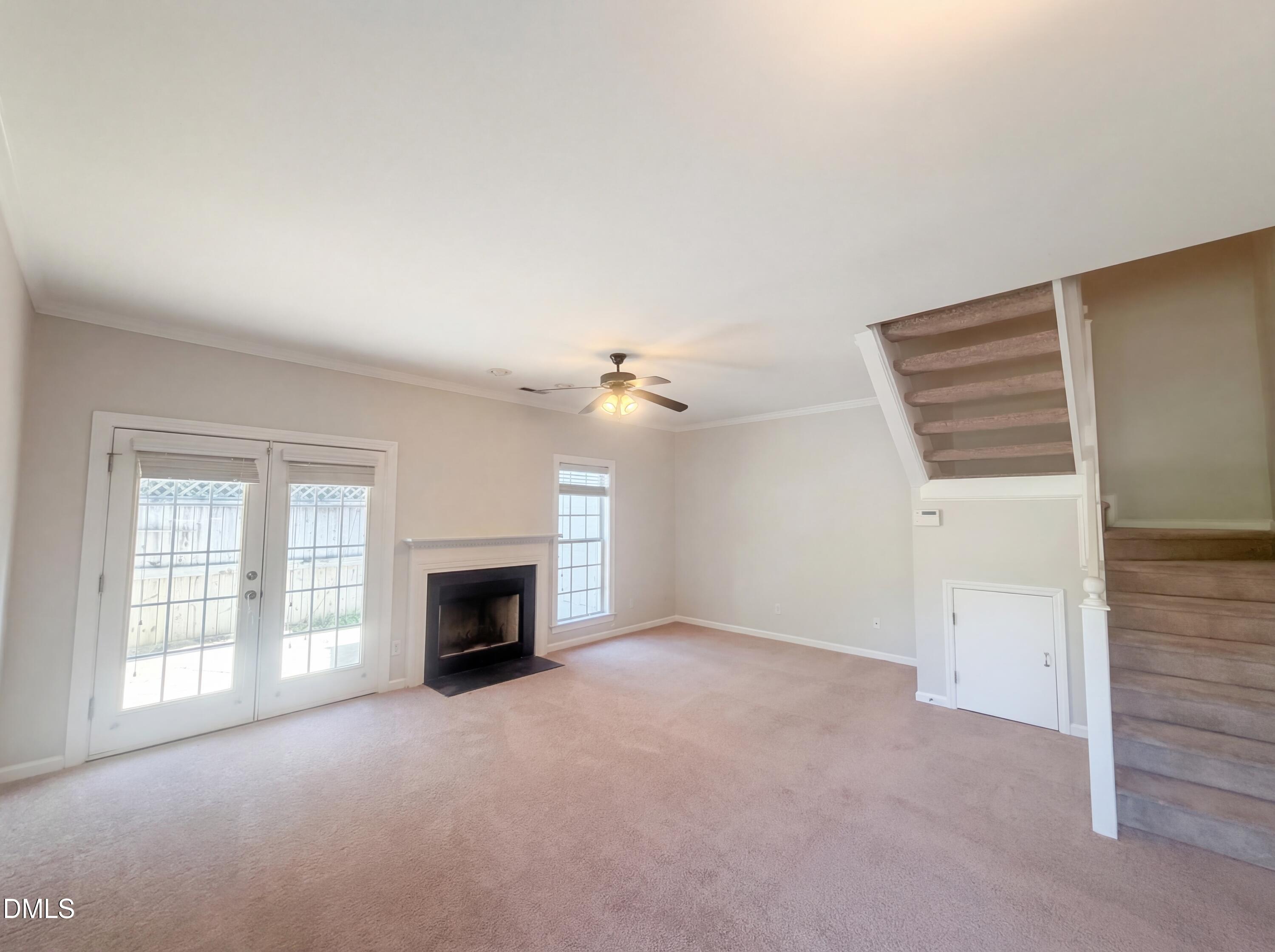 4321 Pine Springs Court Raleigh, NC 27613 - Photo 7 of 15 an empty room with windows and fireplace