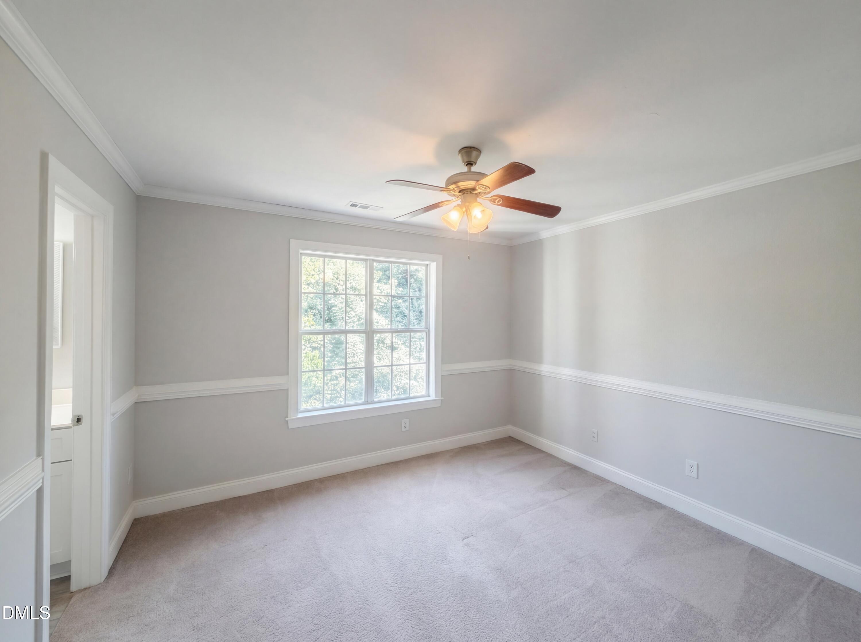 4321 Pine Springs Court Raleigh, NC 27613 - Photo 8 of 15 an empty room with windows and fan