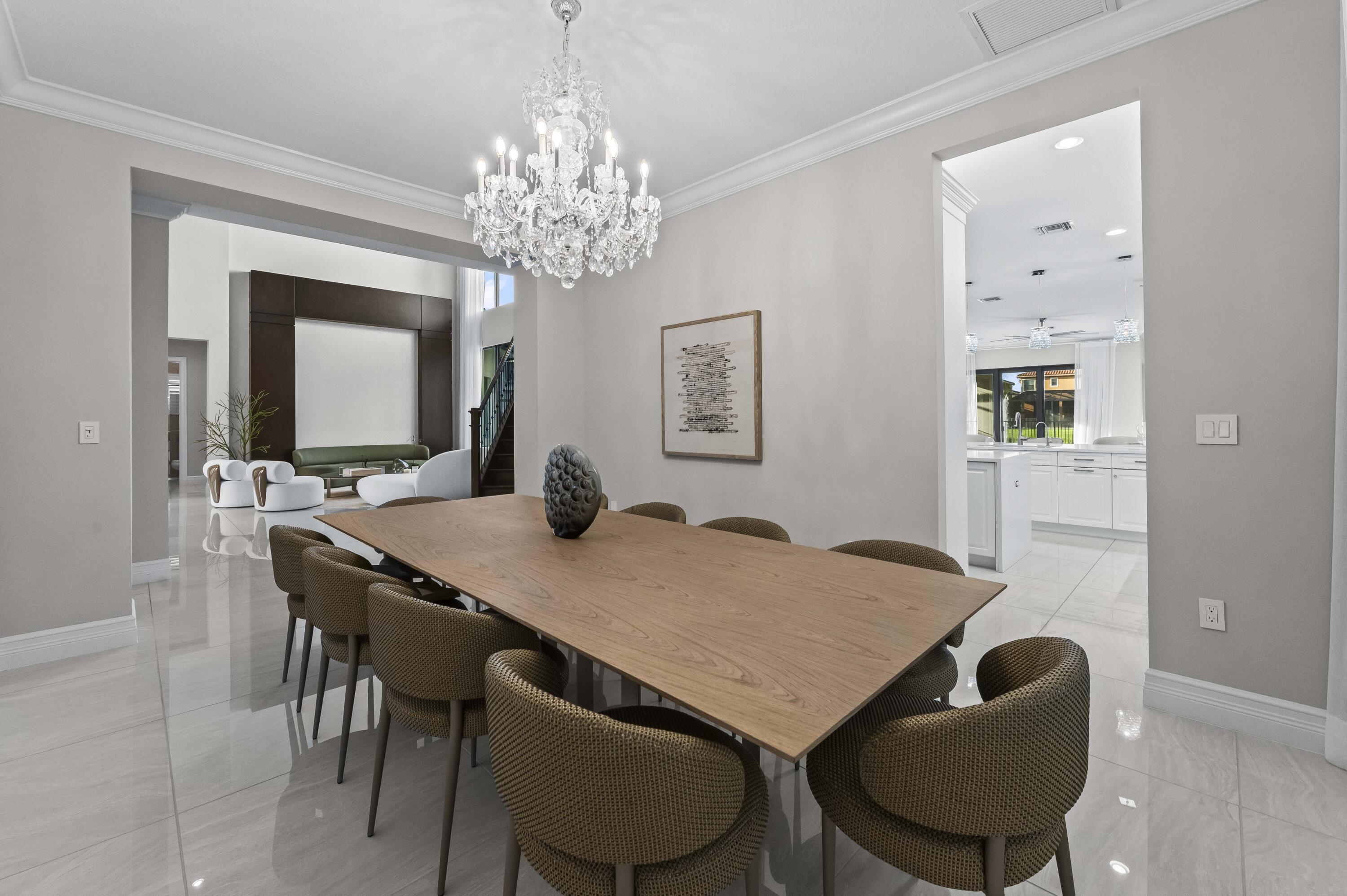 9795 Rennes Lane Delray Beach, FL 33446 - Photo 17 of 79 a view of a dining room with furniture and chandelier
