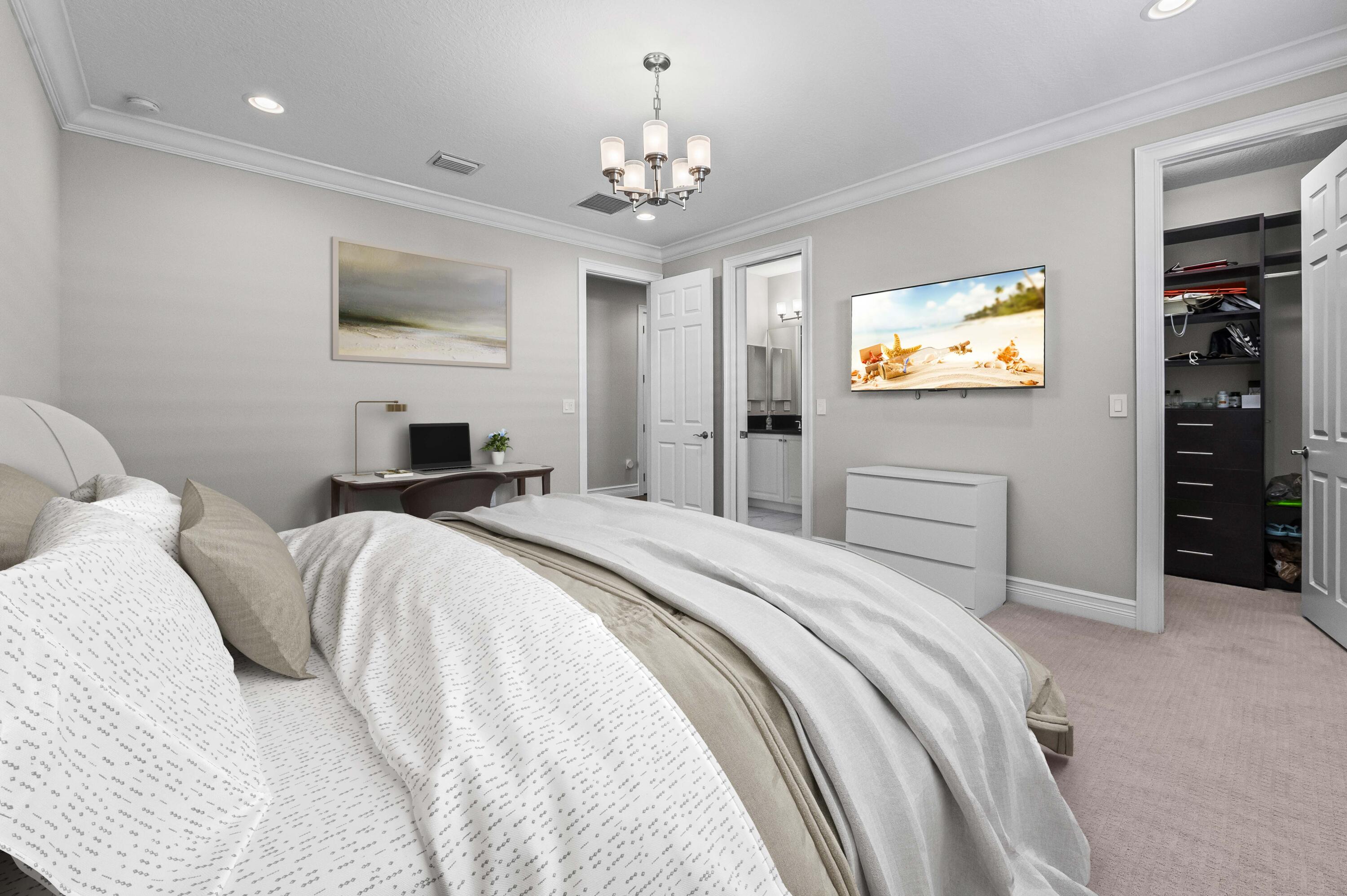 9795 Rennes Lane Delray Beach, FL 33446 - Photo 30 of 79 a bedroom with a bed and a flat screen tv