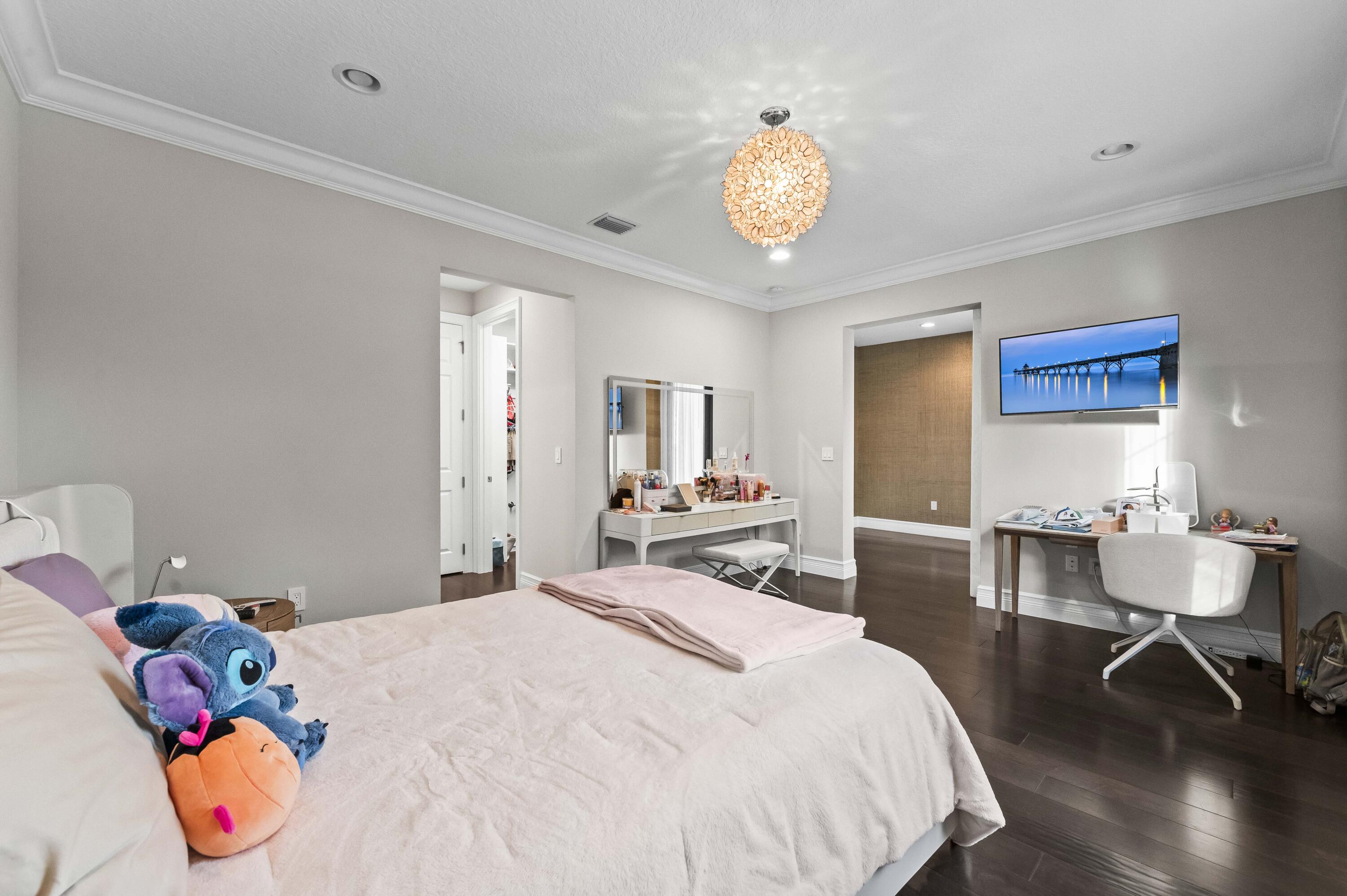 9795 Rennes Lane Delray Beach, FL 33446 - Photo 37 of 79 a bedroom with a bed and wooden floor