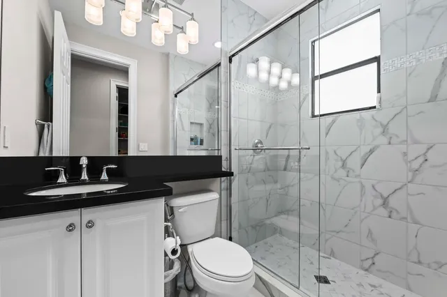 an aerial view of residential houses with outdoor space and lake view