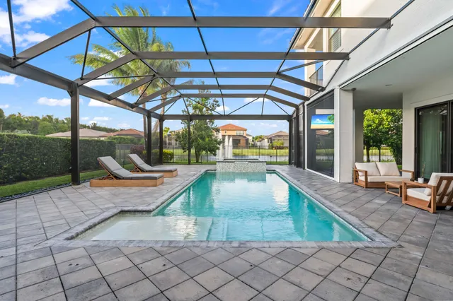 a swimming pool with patio outdoor seating and yard