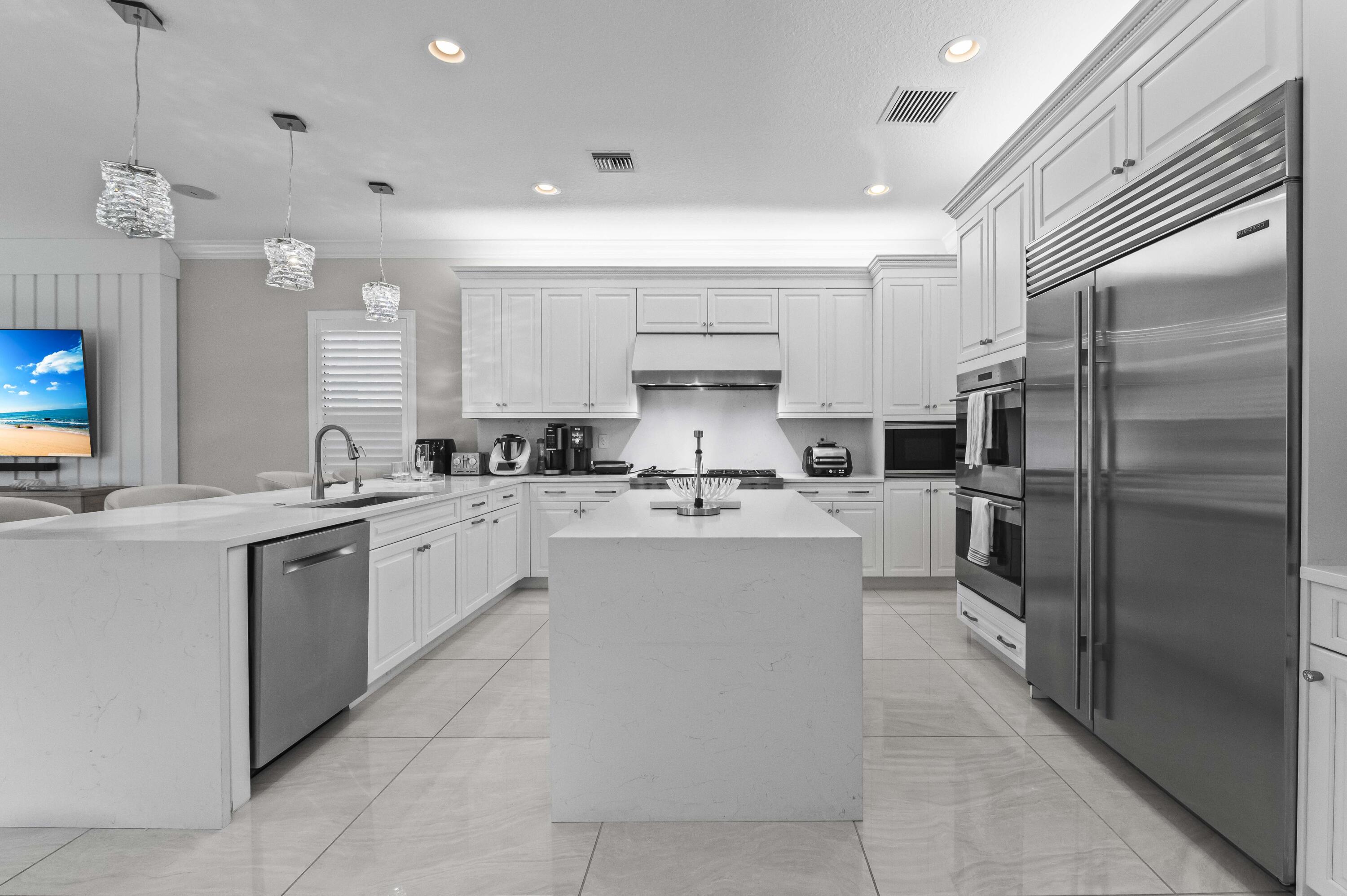 9795 Rennes Lane Delray Beach, FL 33446 - Photo 10 of 79 a kitchen with a refrigerator and a sink