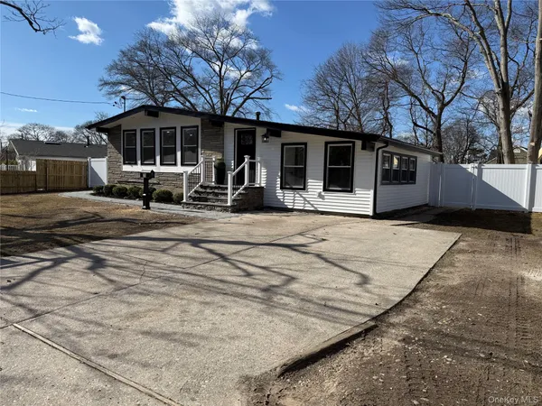 a view of a house with backyard porch and sitting area
