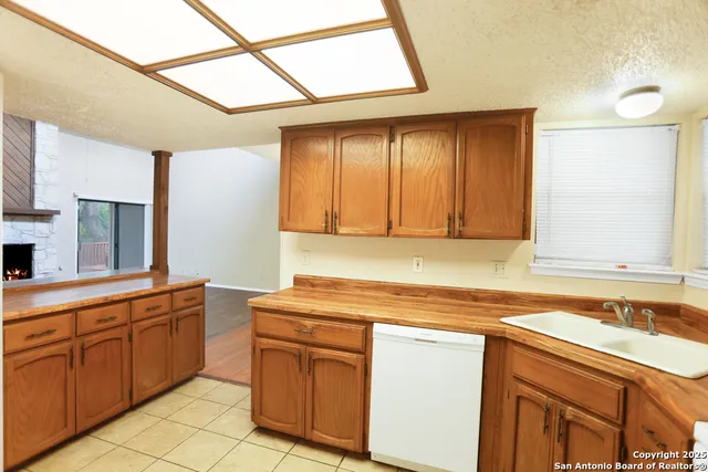 a kitchen with sink cabinets and window