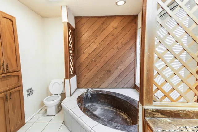 a bathroom with a toilet and a shower curtain