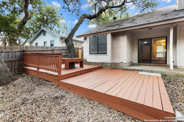 a view of backyard with a deck and wooden floor
