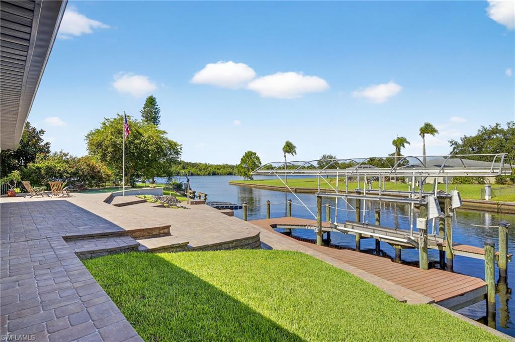 18071 Traverse Drive Alva, FL 33920 - Photo 26 of 50 a view of a swimming pool with an outdoor seating and a yard