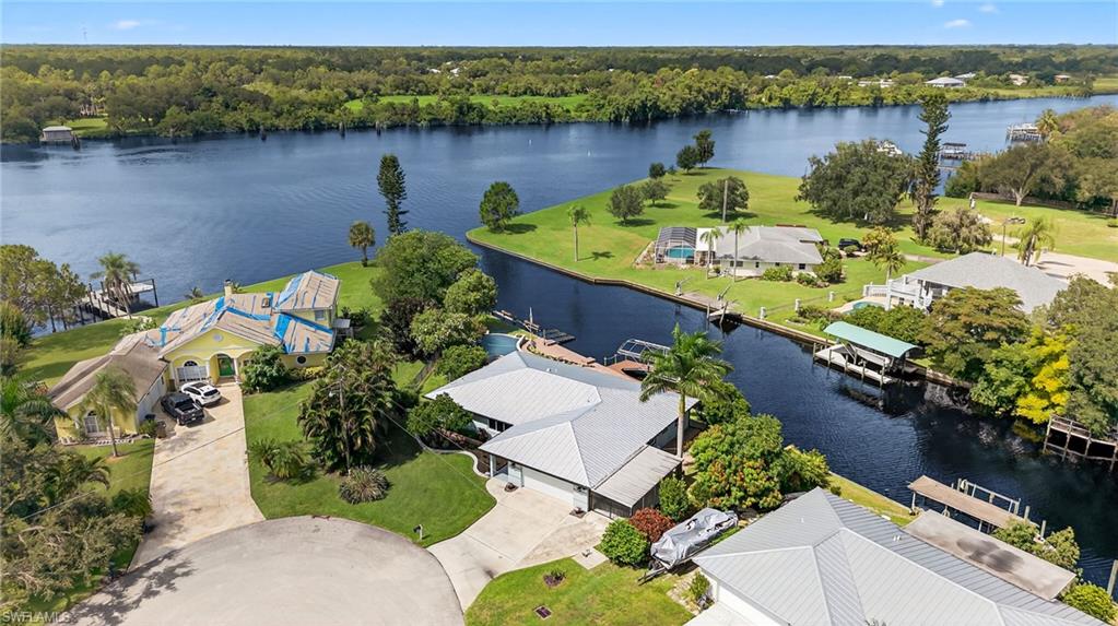 18071 Traverse Drive Alva, FL 33920 - Photo 34 of 50 an aerial view of a house with a yard and lake view