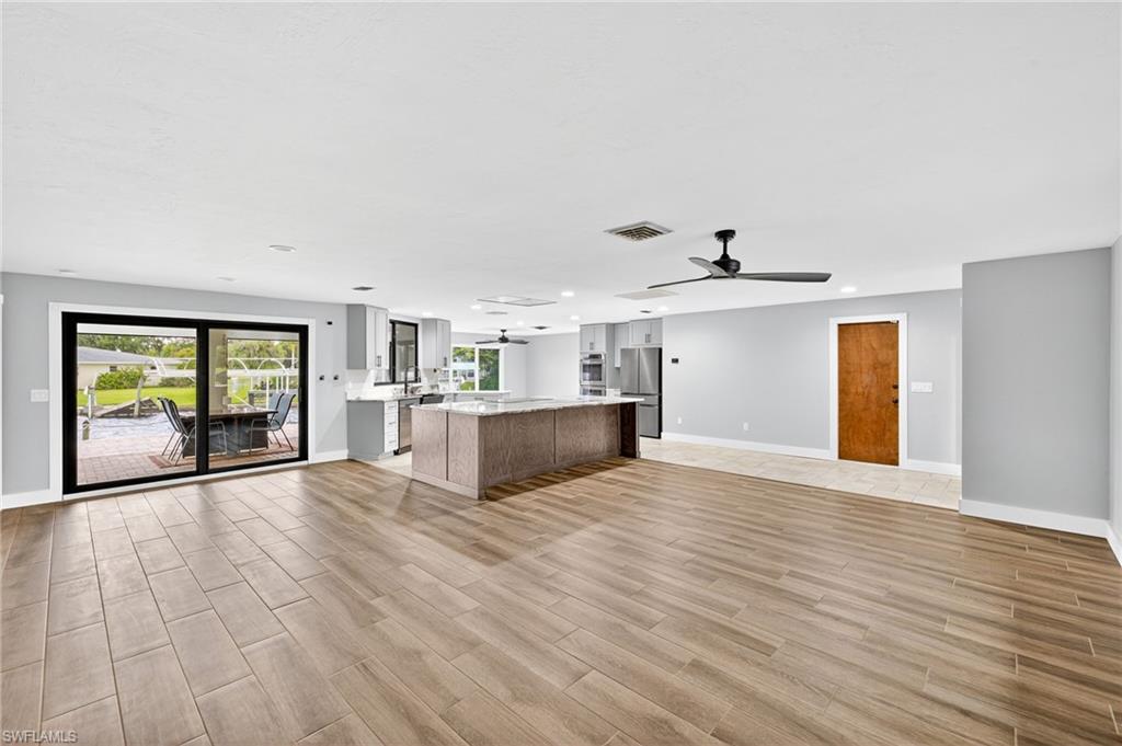 18071 Traverse Drive Alva, FL 33920 - Photo 5 of 50 a view of an empty room with a window and wooden floor