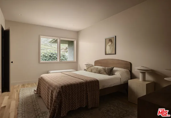 a bedroom with a bed and window