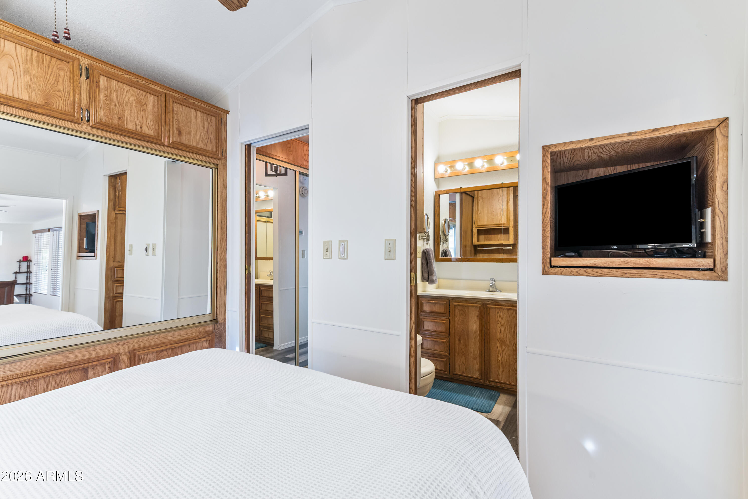 111 South Greenfield Road, Unit 547 Mesa, AZ 85206 - Photo 17 of 38 a bedroom with a bed and a flat screen tv
