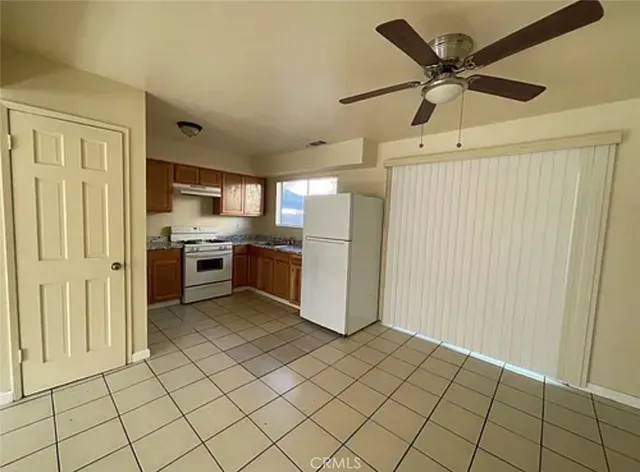 a kitchen with stainless steel appliances a refrigerator and microwave