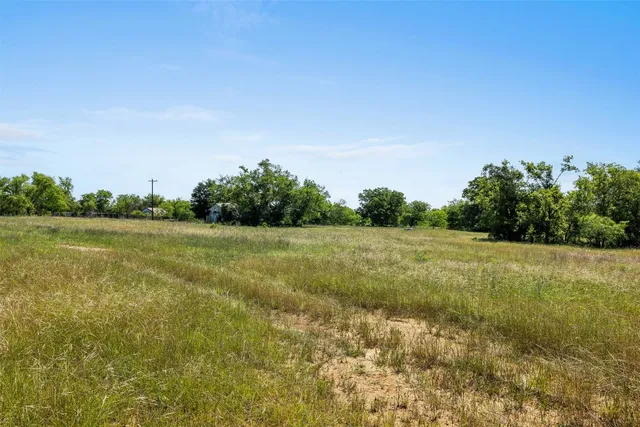 a view of a green field with clear sky