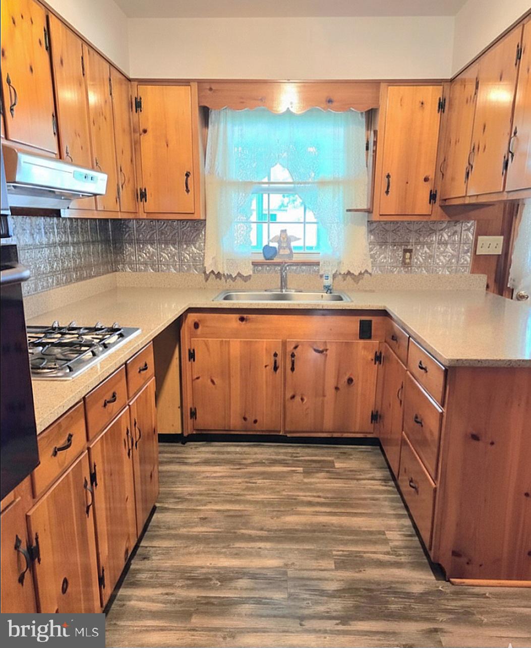 601 Edlon Park Cambridge, MD 21613 - Photo 7 of 19 a large kitchen with stainless steel appliances granite countertop a sink stove and cabinets