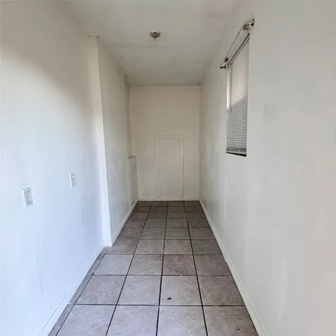 a view of a hallway with a window