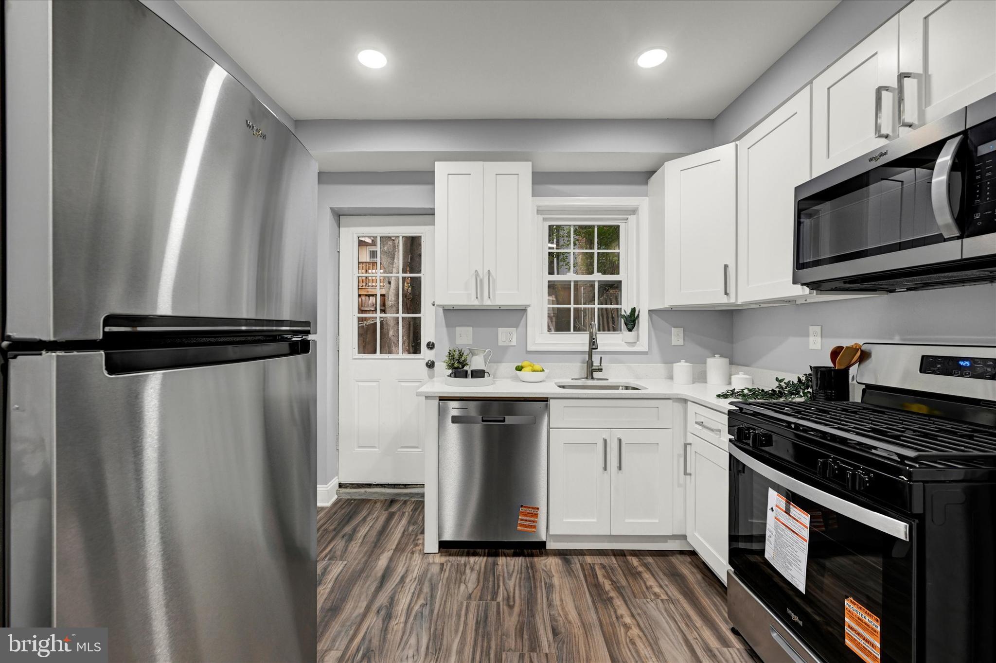 864 Lemmon Street Baltimore, MD 21201 - Photo 6 of 18 a kitchen with stainless steel appliances a sink dishwasher a refrigerator and a stove top oven
