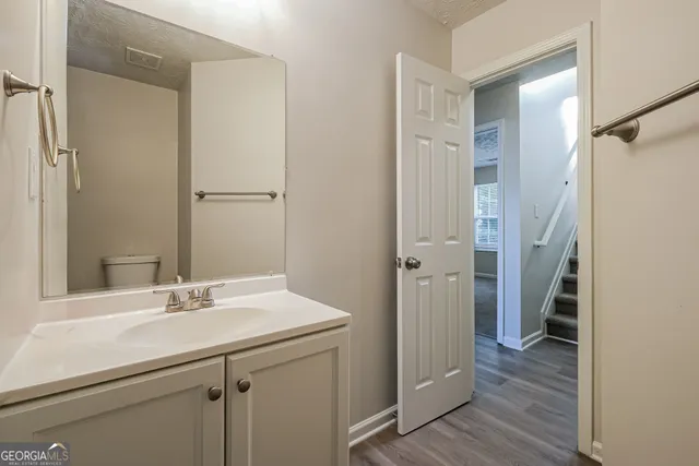 a bathroom with a sink shower and a mirror