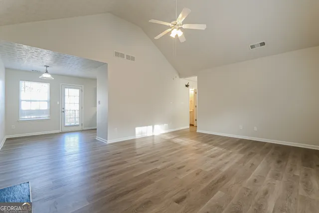 wooden floor in an empty room with a window