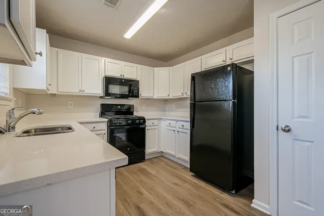 a kitchen with a refrigerator stove and sink