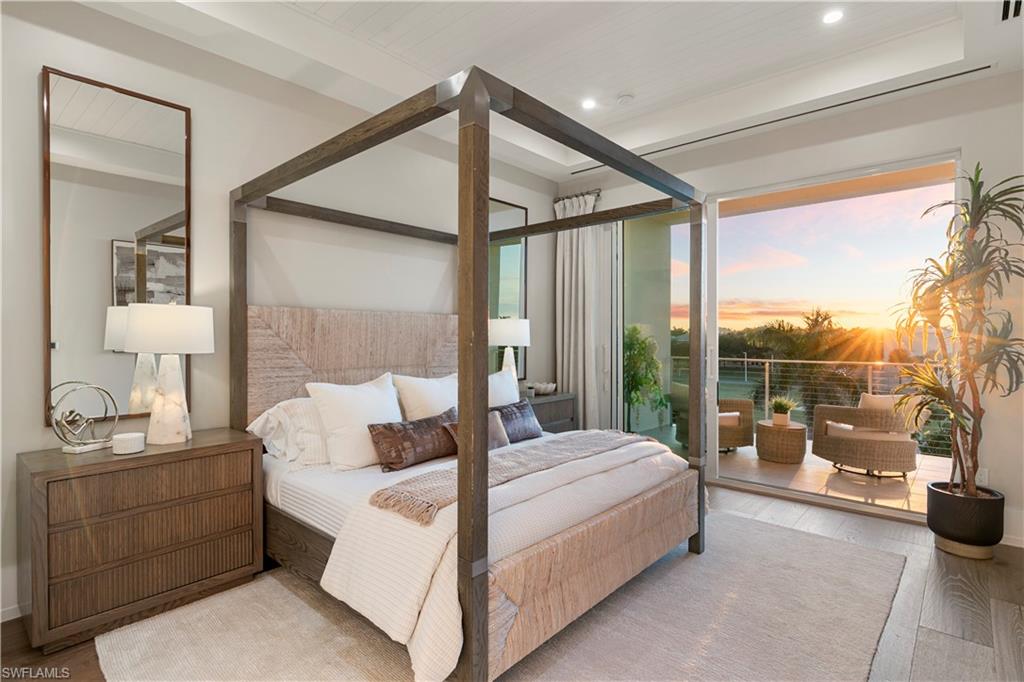 201 8th Street South, Unit 301 Naples, FL 34102 - Photo 18 of 43 a bedroom with a bed and a large window
