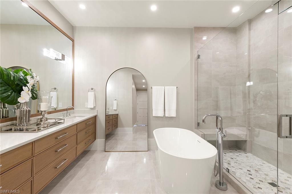 201 8th Street South, Unit 301 Naples, FL 34102 - Photo 21 of 43 a spacious bathroom with a sink a toilet and shower