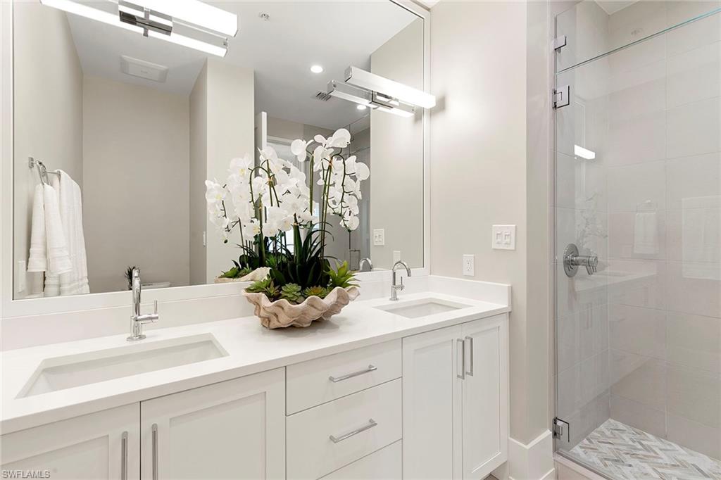 201 8th Street South, Unit 301 Naples, FL 34102 - Photo 24 of 43 a bathroom with a sink and a mirror