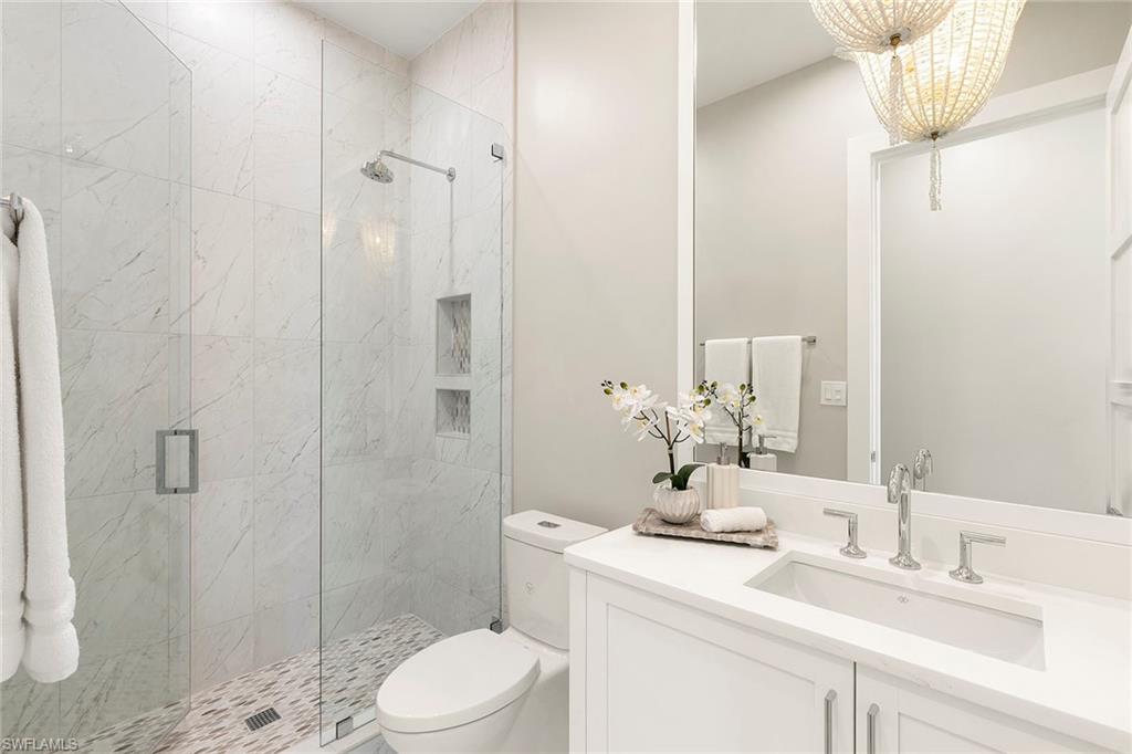 201 8th Street South, Unit 301 Naples, FL 34102 - Photo 26 of 43 a bathroom with a sink a toilet and shower