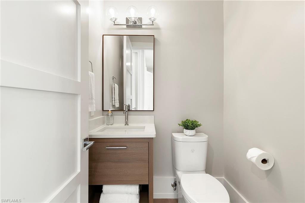 201 8th Street South, Unit 301 Naples, FL 34102 - Photo 27 of 43 a bathroom with a sink vanity mirror and toilet