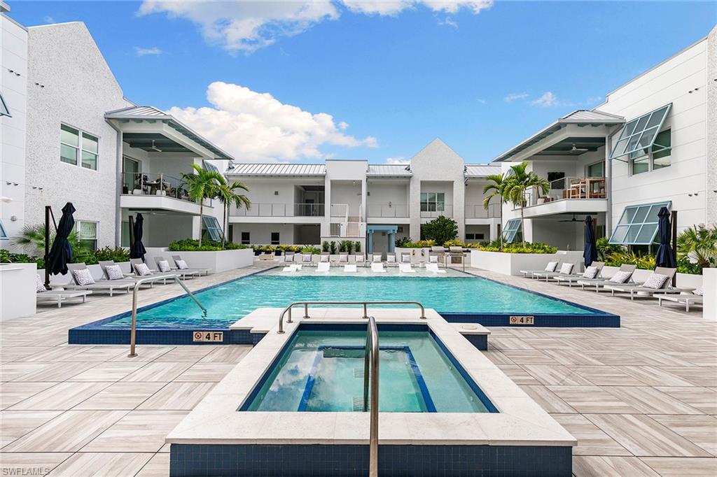 201 8th Street South, Unit 301 Naples, FL 34102 - Photo 31 of 43 a swimming pool with outdoor seating and yard