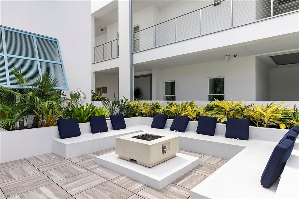 201 8th Street South, Unit 301 Naples, FL 34102 - Photo 33 of 43 a white vase with flowers sitting on a table