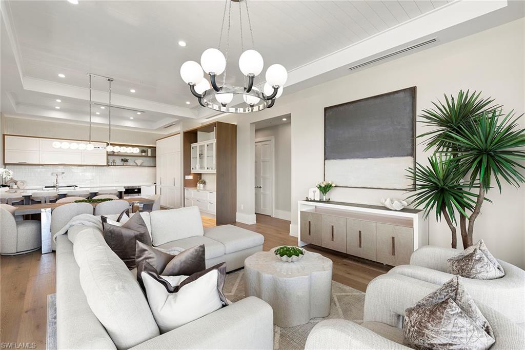 201 8th Street South, Unit 301 Naples, FL 34102 - Photo 4 of 43 a living room with furniture and a chandelier