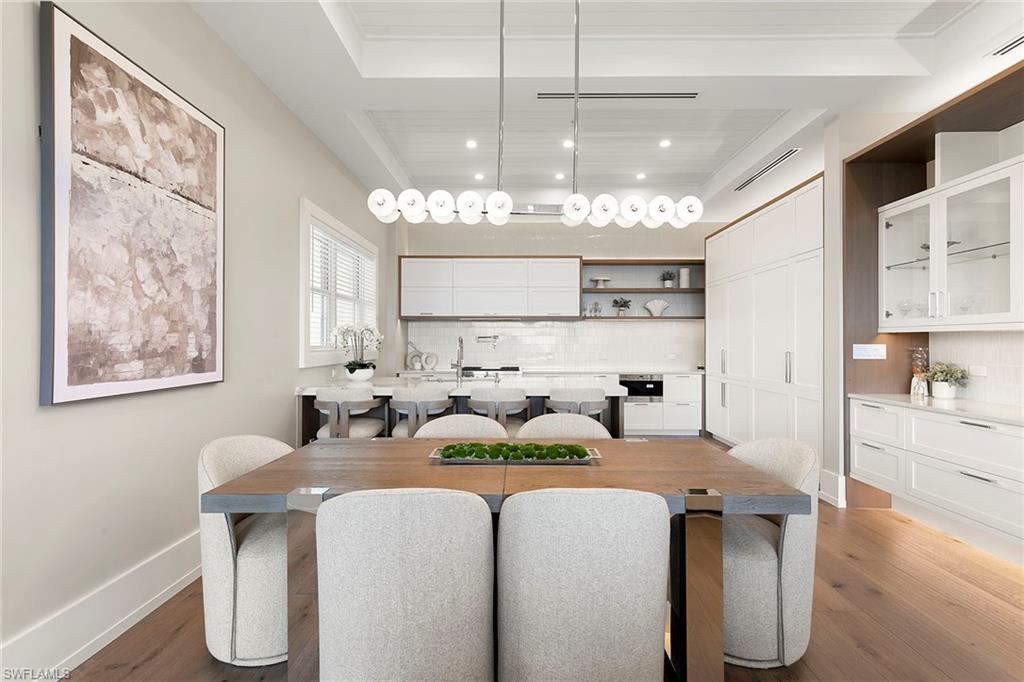201 8th Street South, Unit 301 Naples, FL 34102 - Photo 6 of 43 a kitchen with kitchen island granite countertop a sink cabinets and window