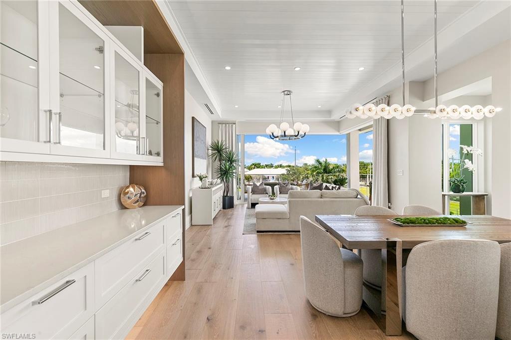 201 8th Street South, Unit 301 Naples, FL 34102 - Photo 7 of 43 a large white kitchen with a large window and stainless steel appliances