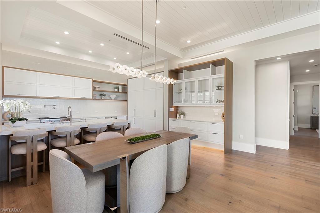 201 8th Street South, Unit 301 Naples, FL 34102 - Photo 8 of 43 a open kitchen with stainless steel appliances granite countertop a sink and a refrigerator