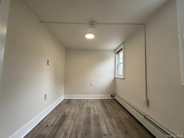 12 Grove Street, Unit C Beacon, NY 12508 - Photo 10 of 13 Spare room with baseboard heating, dark wood-style flooring, and a smoke detector